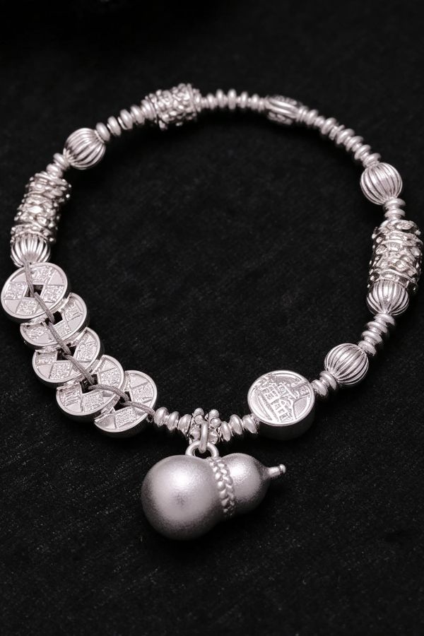 close-up silver bracelet with coin details Chinese Heritage Charm Bracelet with Timeless Meaning - Image 2