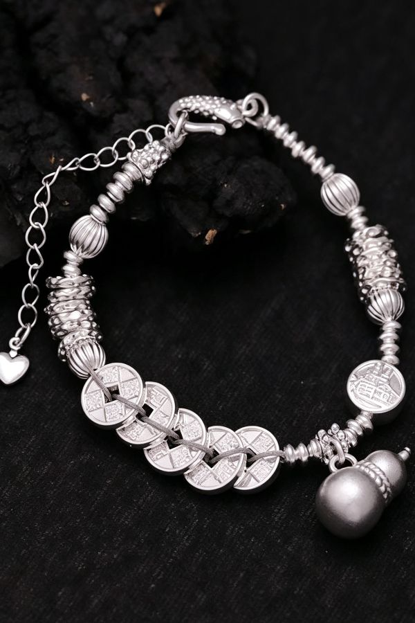 silver bracelet with heart charm and black texture background Chinese Heritage Charm Bracelet with Timeless Meaning