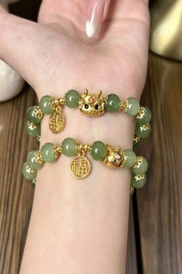 Green beaded bracelet on wrist Eastern Elegance Butterfly Beaded Bracelet - Image 3
