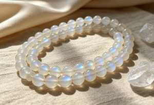 Moonstone vs Other White Gemstones: Differences, Meanings, and How to Choose the Right Gemstone moonstone mala on linen fabric