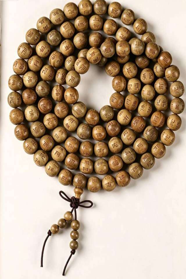Sandalwood mala on book page Forest Whisper Sandalwood 108 Mala - Image 4