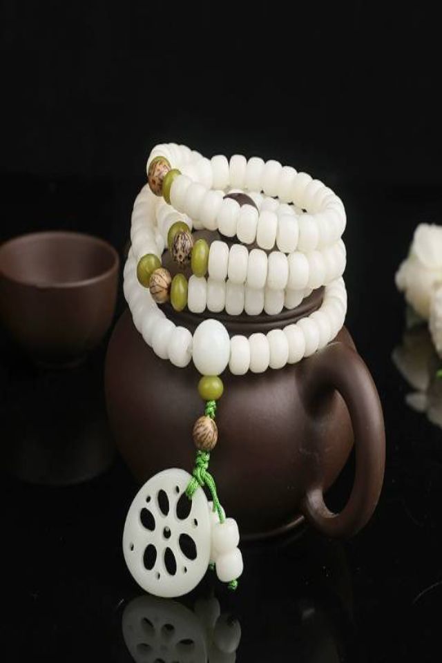 White Bodhi 108 mala on dark teapot White Bodhi 108 Mala: Zen & Mindful Connection - Image 3